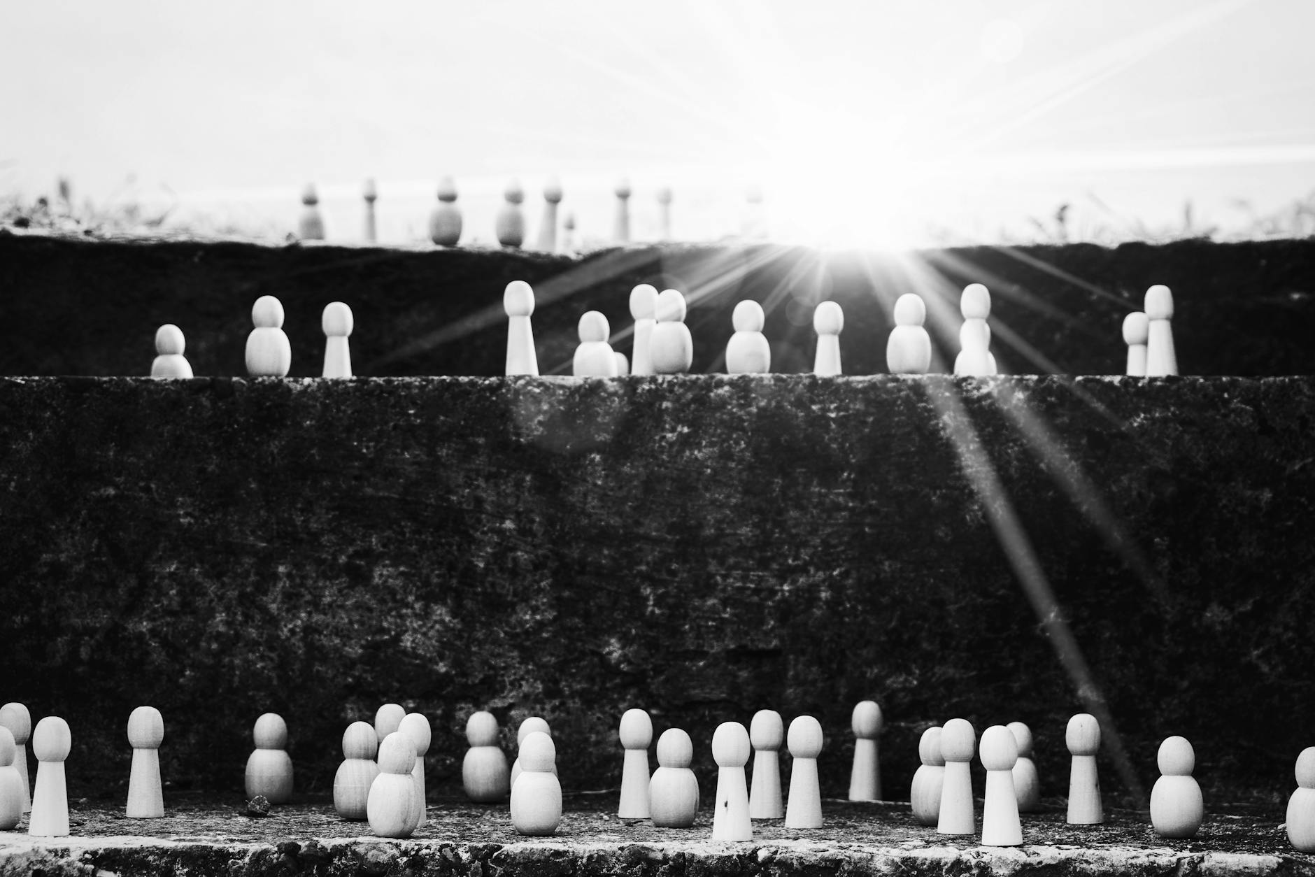 set of figurines on steps representing social ladder